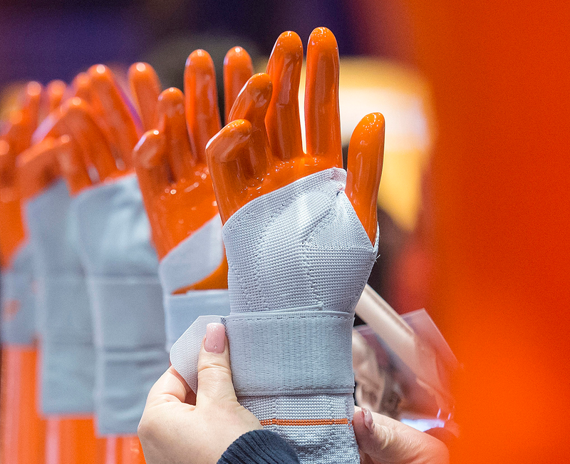 A woman fixes a bandage at the Sporlastic Orthopaedics booth. Image: Jens Meyer/AP